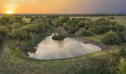 a group of people standing on top of a lake