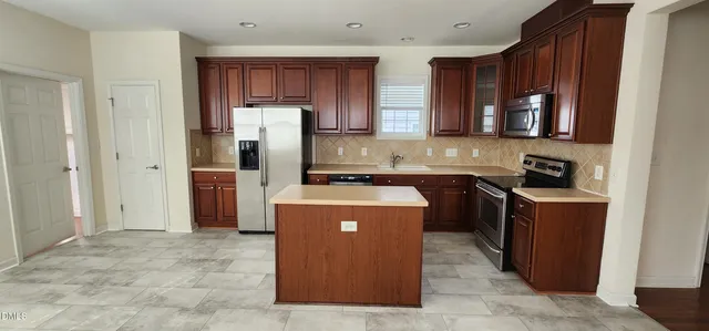 a kitchen with a refrigerator and a sink