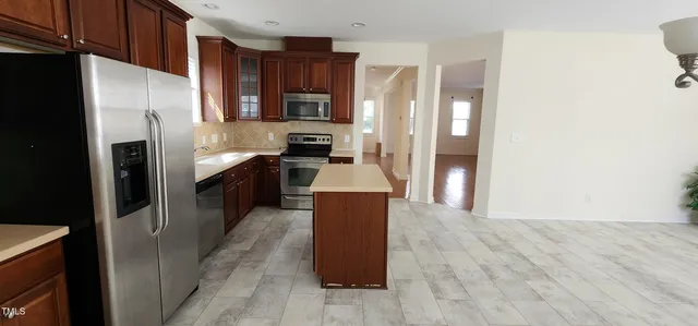 a large kitchen with cabinets and stainless steel appliances
