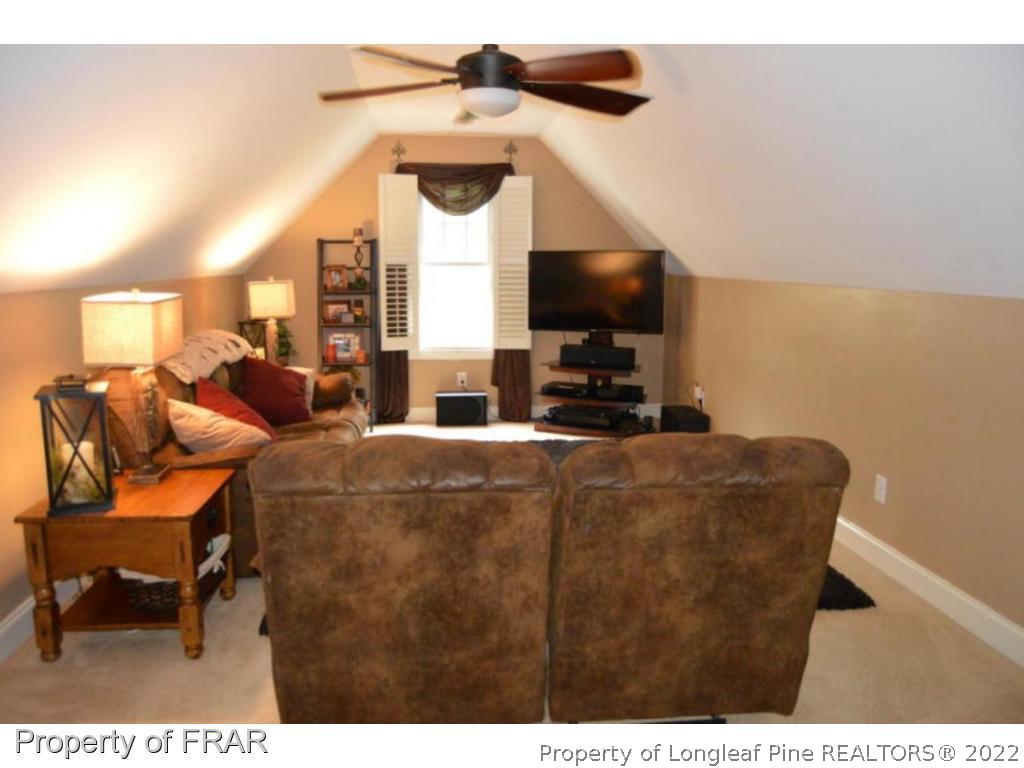 3940 Niagara Carthage Road Whispering Pines, NC 28327 - Photo 14 of 26 a living room with furniture and a flat screen tv