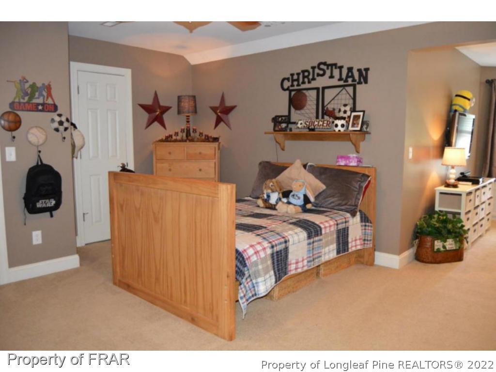 3940 Niagara Carthage Road Whispering Pines, NC 28327 - Photo 17 of 26 a bedroom with a bed and cabinets