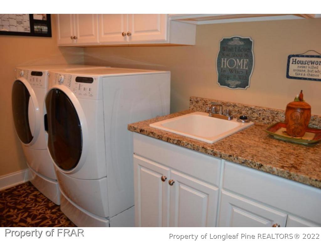 3940 Niagara Carthage Road Whispering Pines, NC 28327 - Photo 24 of 26 a bathroom with a sink and a mirror