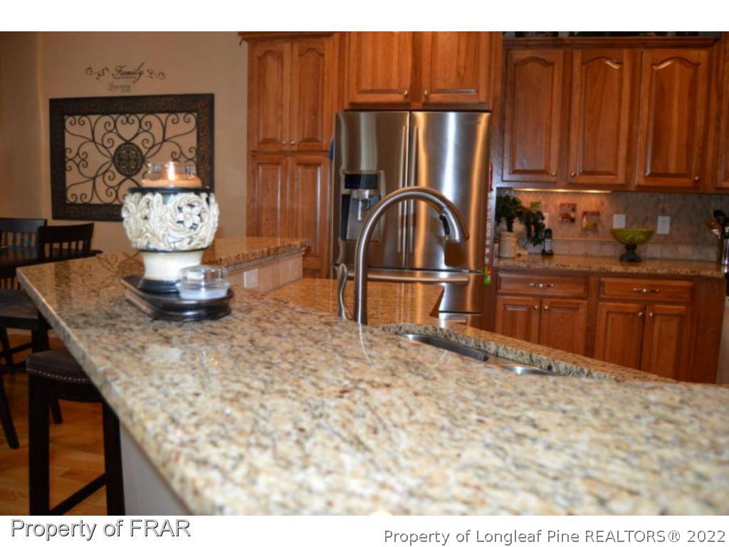 3940 Niagara Carthage Road Whispering Pines, NC 28327 - Photo 3 of 26 a kitchen with stainless steel appliances granite countertop a refrigerator and stove