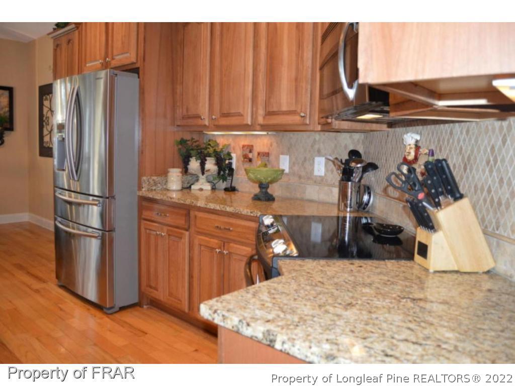 3940 Niagara Carthage Road Whispering Pines, NC 28327 - Photo 4 of 26 a kitchen with refrigerator and cabinets