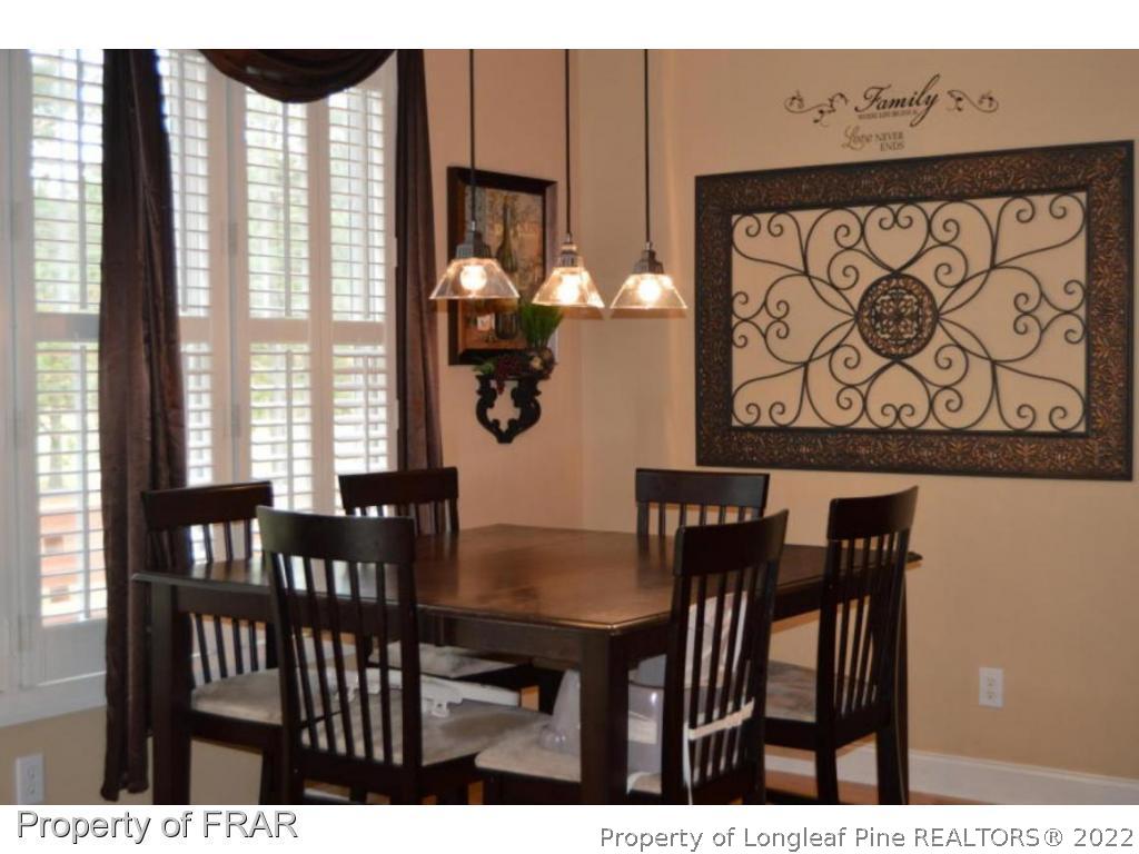 3940 Niagara Carthage Road Whispering Pines, NC 28327 - Photo 9 of 26 a view of a dining room with furniture and a window