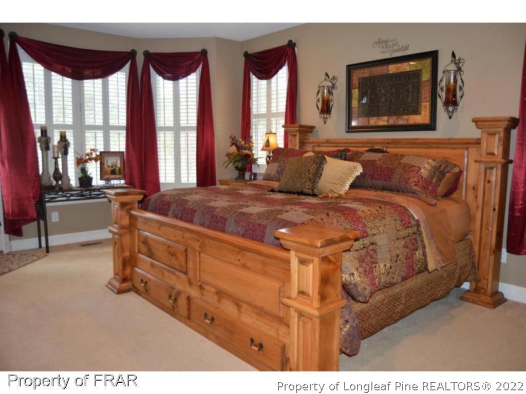 3940 Niagara Carthage Road Whispering Pines, NC 28327 - Photo 10 of 26 a bedroom with a bed and window