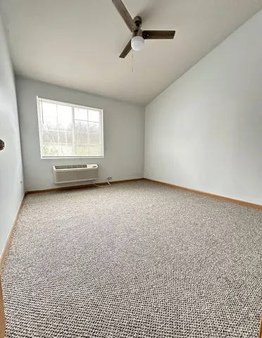 an empty room with a empty space and windows