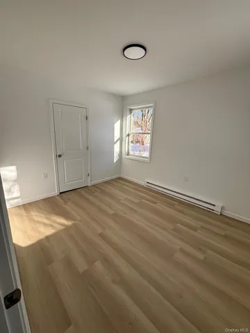 a view of empty room with window and ceiling fan