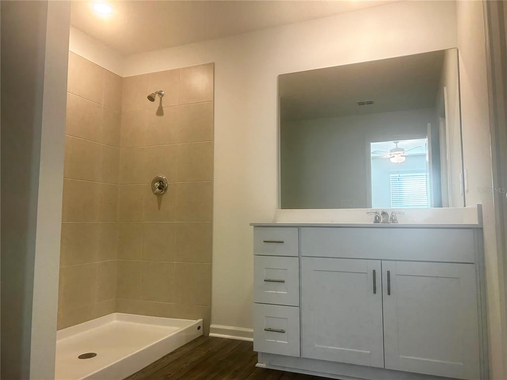 8480 Southwest 41st Circle Ocala, FL 34476 - Photo 29 of 41 a bathroom with a shower sink and mirror