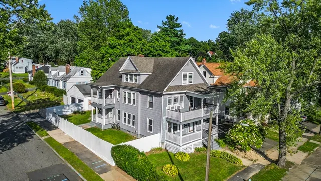 an aerial view of a house with swimming pool and garden