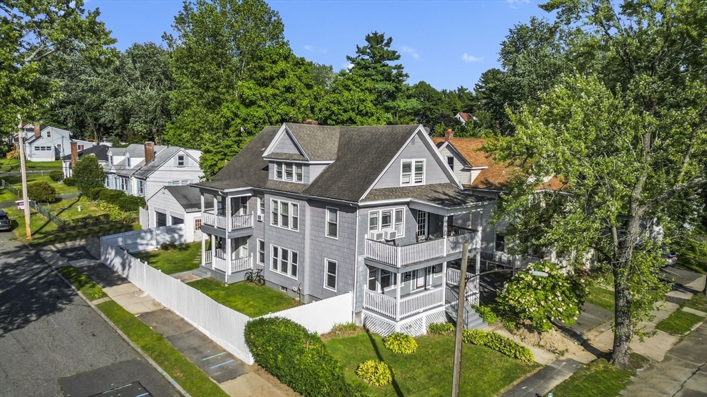 an aerial view of a house with swimming pool and garden