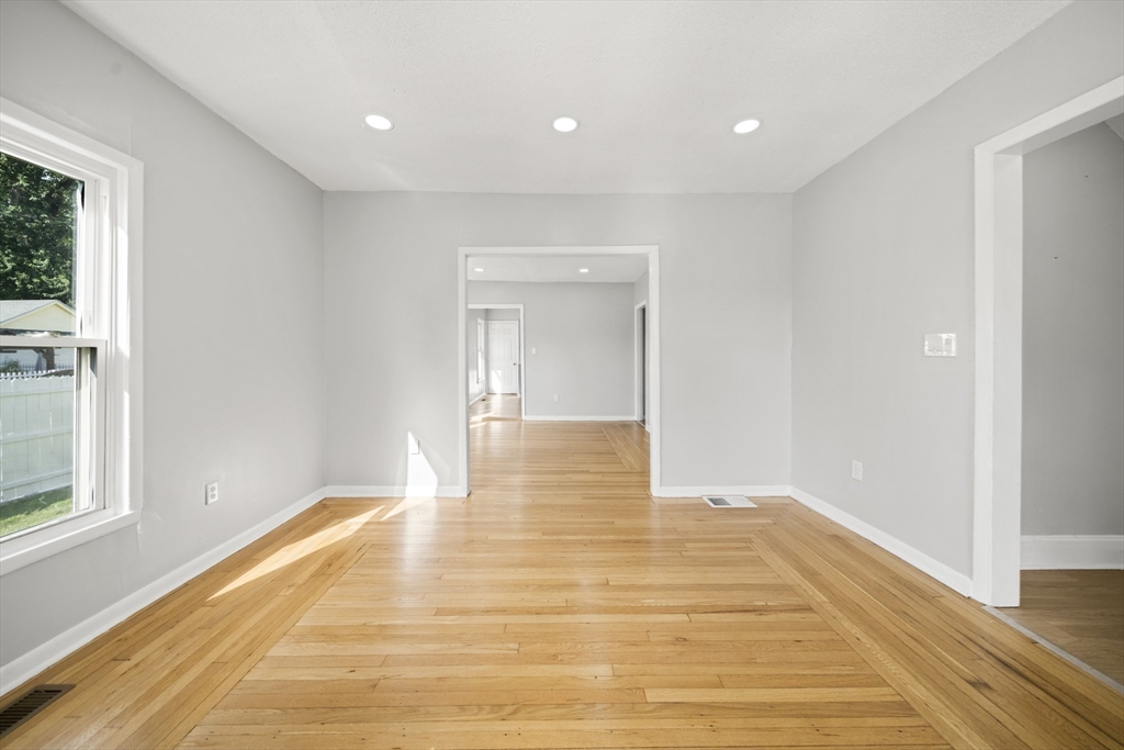 57 Narragansett Street Springfield, MA 01107 - Photo 13 of 41 a view of an empty room with wooden floor and a window