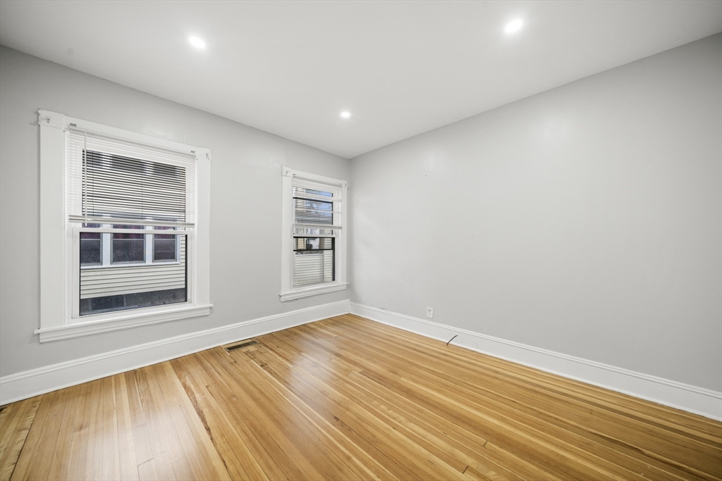 57 Narragansett Street Springfield, MA 01107 - Photo 14 of 41 a view of empty room with wooden floor and fan