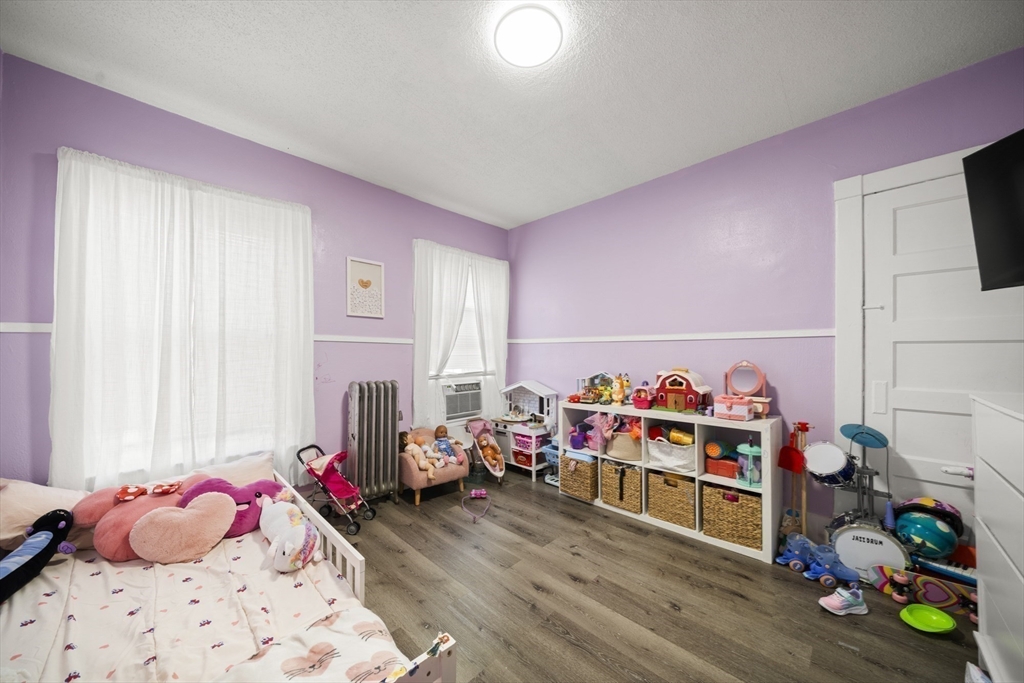 57 Narragansett Street Springfield, MA 01107 - Photo 21 of 41 a bedroom with furniture and a wooden floor