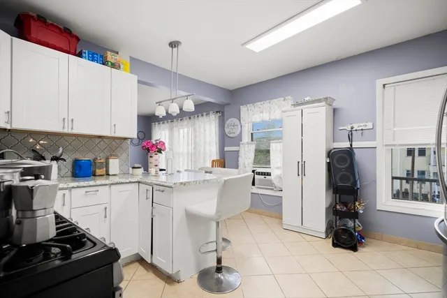 a kitchen with refrigerator and cabinets