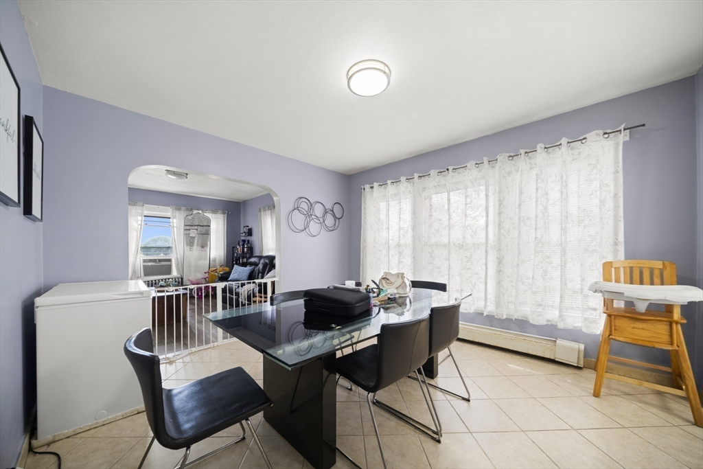 57 Narragansett Street Springfield, MA 01107 - Photo 27 of 41 a view of a dining room with furniture and a window