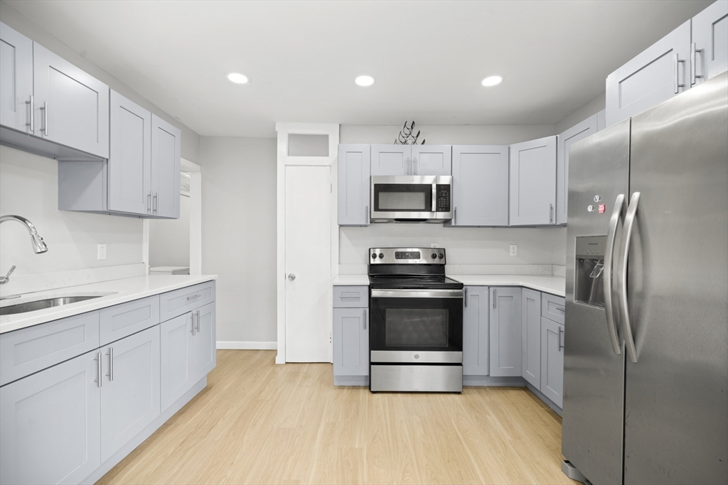57 Narragansett Street Springfield, MA 01107 - Photo 3 of 41 a kitchen with stainless steel appliances a stove a sink and a refrigerator