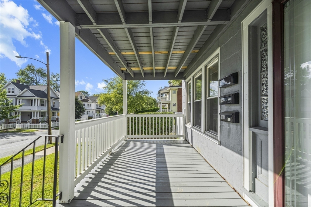 57 Narragansett Street Springfield, MA 01107 - Photo 37 of 41 a view of a porch with wooden floor and iron stairs