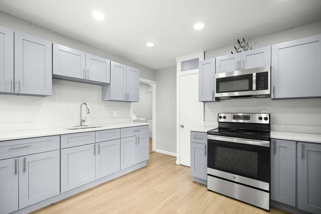 57 Narragansett Street Springfield, MA 01107 - Photo 4 of 41 a kitchen with sink a microwave and cabinets