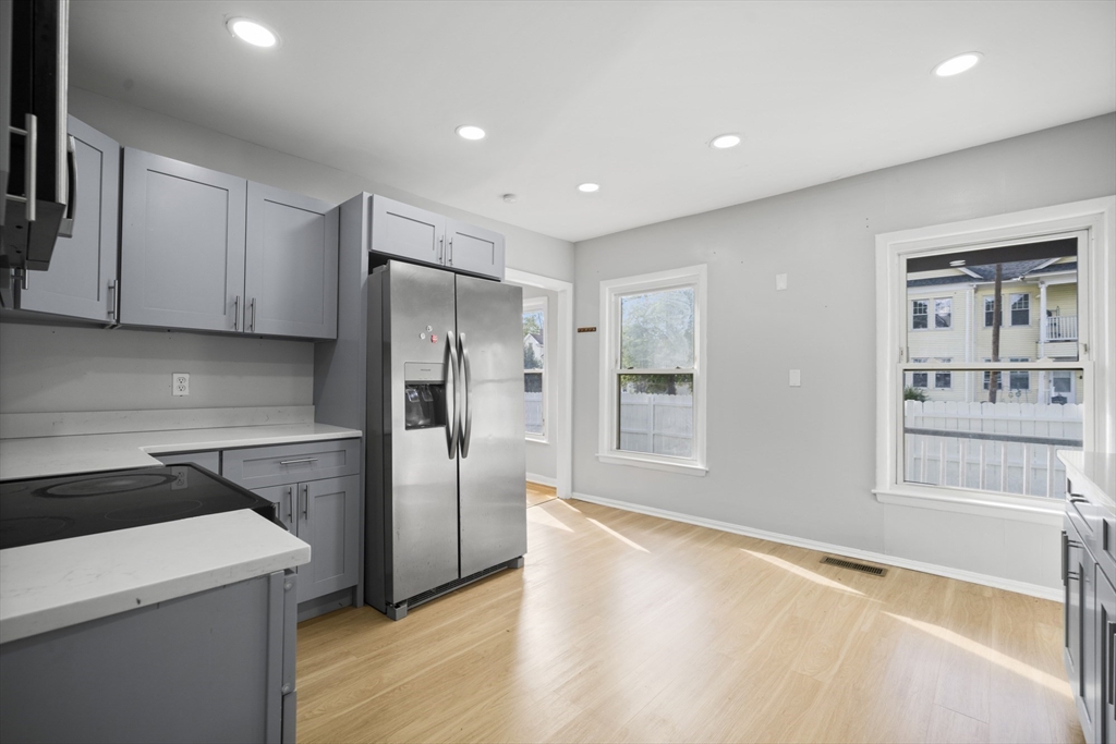57 Narragansett Street Springfield, MA 01107 - Photo 5 of 41 a kitchen with granite countertop a refrigerator and a stove top oven