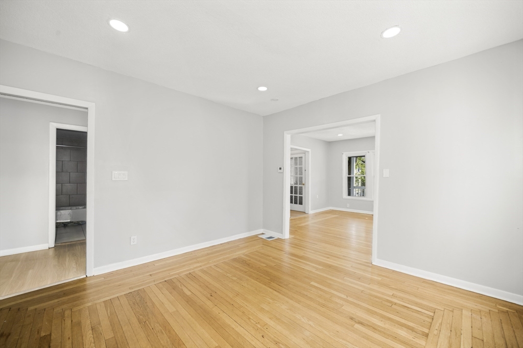 57 Narragansett Street Springfield, MA 01107 - Photo 8 of 41 a view of empty room with wooden floor and fan