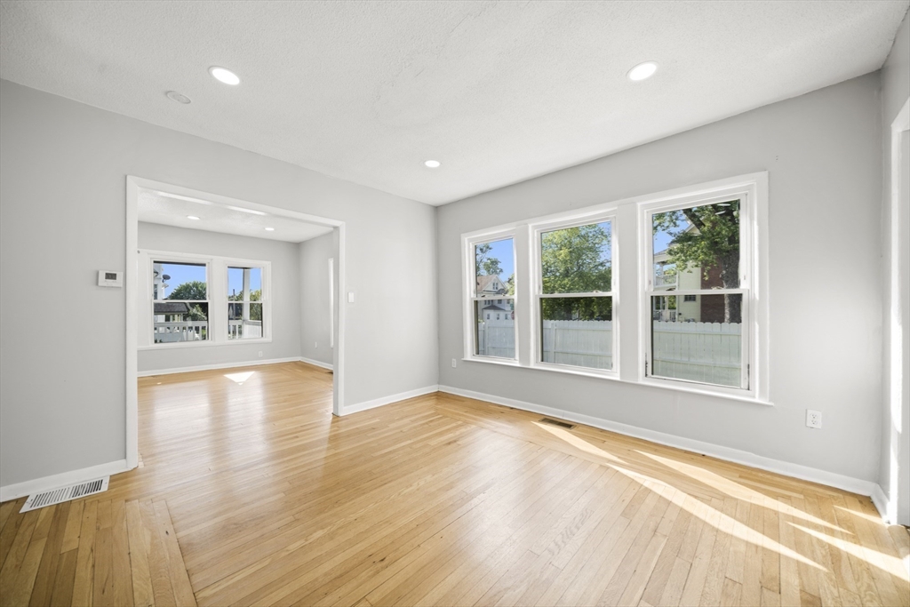 57 Narragansett Street Springfield, MA 01107 - Photo 9 of 41 a view of an empty room with wooden floor and a window