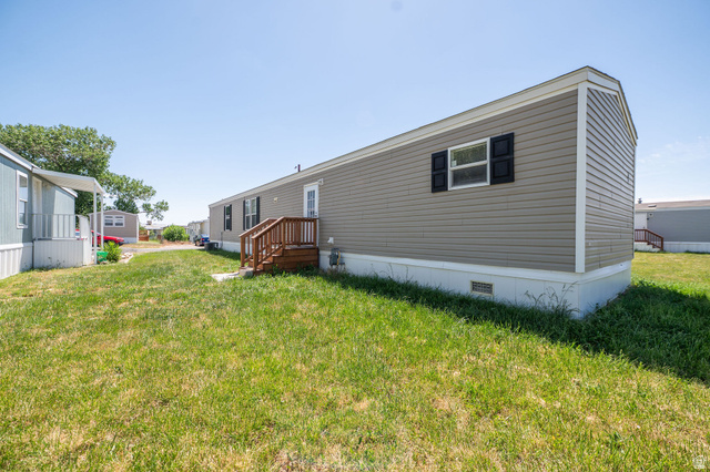 2491 Highway 89, Unit 403 Pleasant View, UT 84404 - Photo 32 of 32 Exterior with horizontal siding, black window shutters, and a white trim