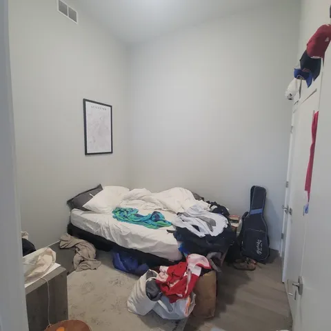 a bedroom with a bed and a table in it