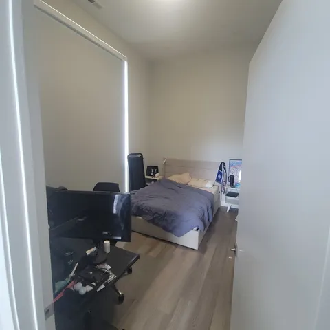 a bedroom with a bed and dresser