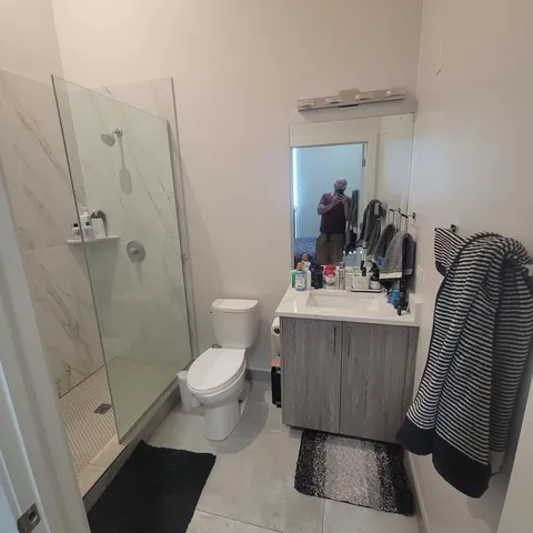 a bathroom with a sink toilet and shower