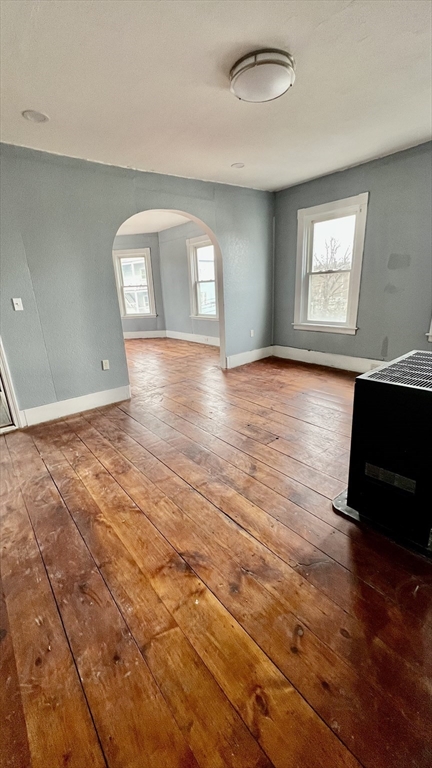 564 Main Street Southbridge, MA 01550 - Photo 4 of 18 an empty room with wooden floor and windows