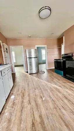 a view of a hardwood floor and a window
