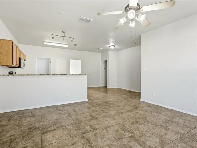 a view of a kitchen with microwave and cabinets