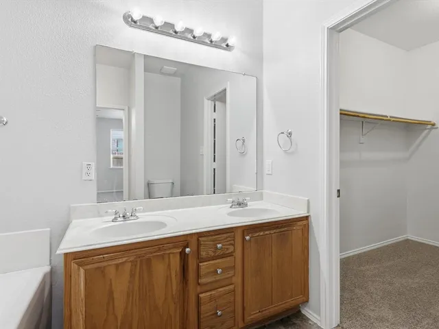 a bathroom with a sink double vanity and a mirror