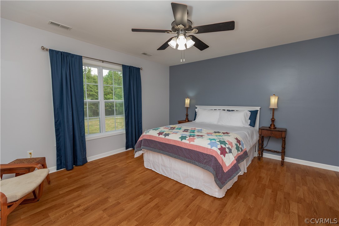 1394 Falls Road Victoria, VA 23974 - Photo 13 of 45 a bedroom with a large bed and a chandelier
