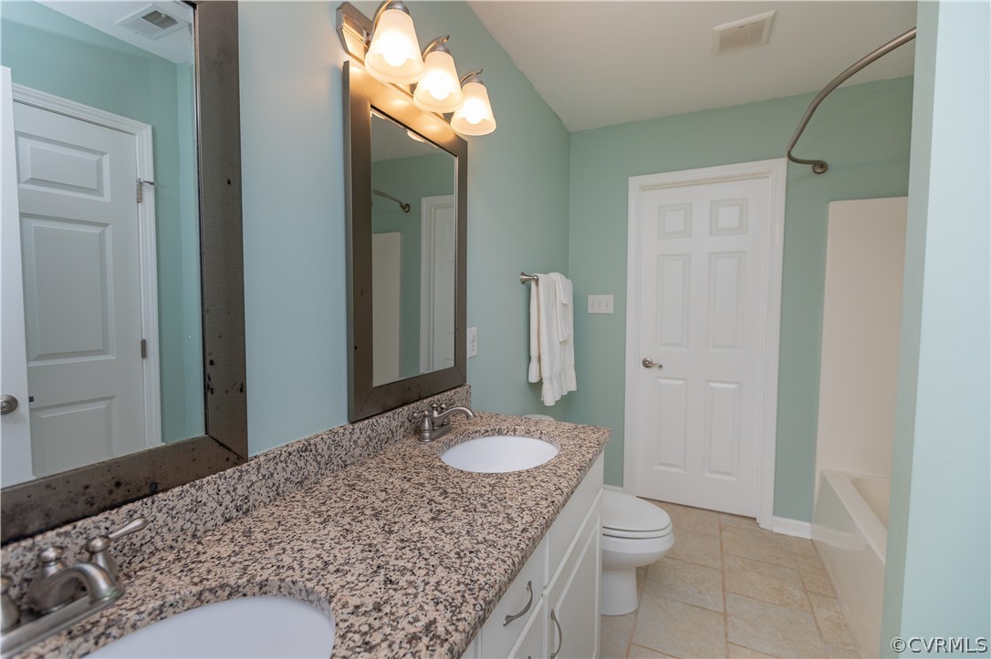 1394 Falls Road Victoria, VA 23974 - Photo 17 of 45 a bathroom with a granite countertop sink toilet and shower
