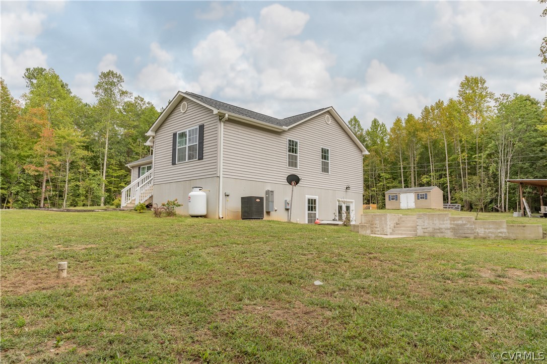 1394 Falls Road Victoria, VA 23974 - Photo 33 of 45 a white house with a big yard and large trees with wooden fence
