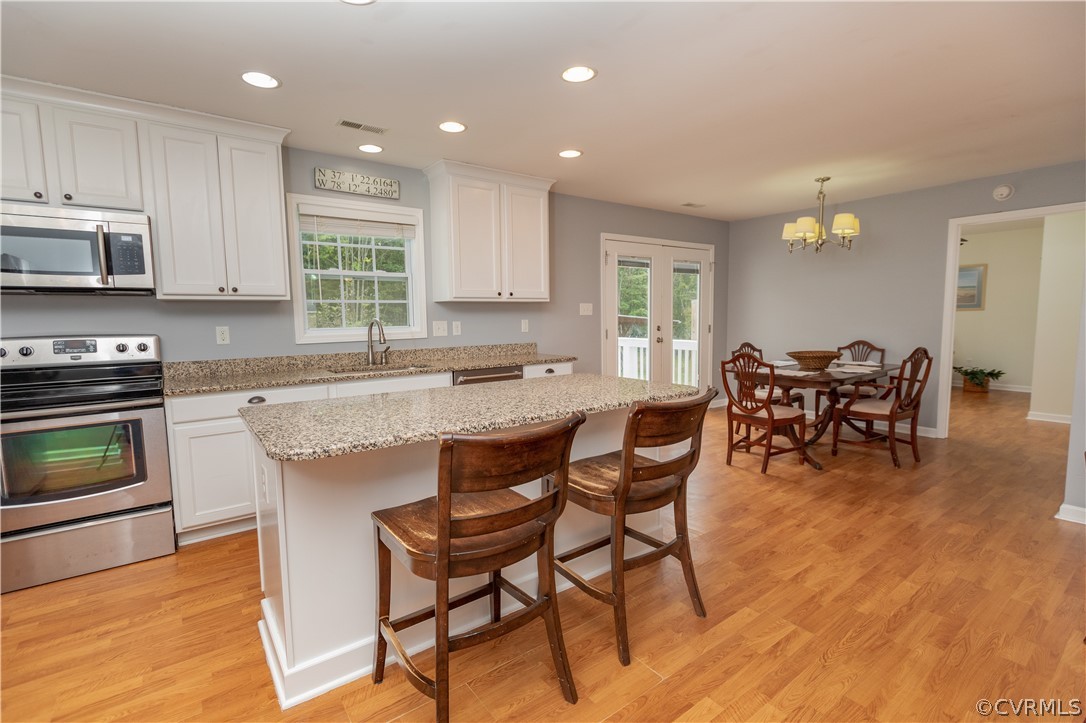 1394 Falls Road Victoria, VA 23974 - Photo 5 of 45 a kitchen with granite countertop dining table chairs and granite counter tops