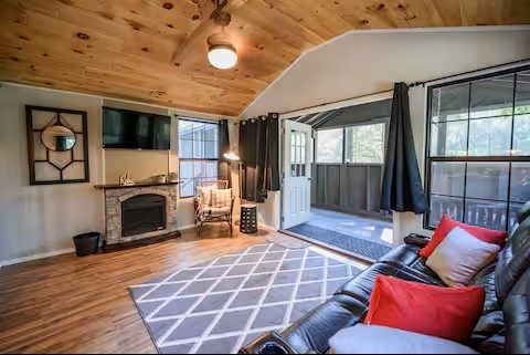 233 Porterfield Road Readyville, TN 37149 - Photo 16 of 32 a living room with furniture a flat screen tv and a fireplace