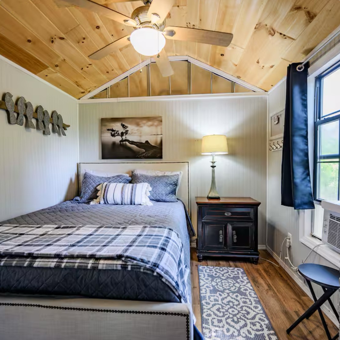 233 Porterfield Road Readyville, TN 37149 - Photo 29 of 32 a bedroom with a bed and wooden floor