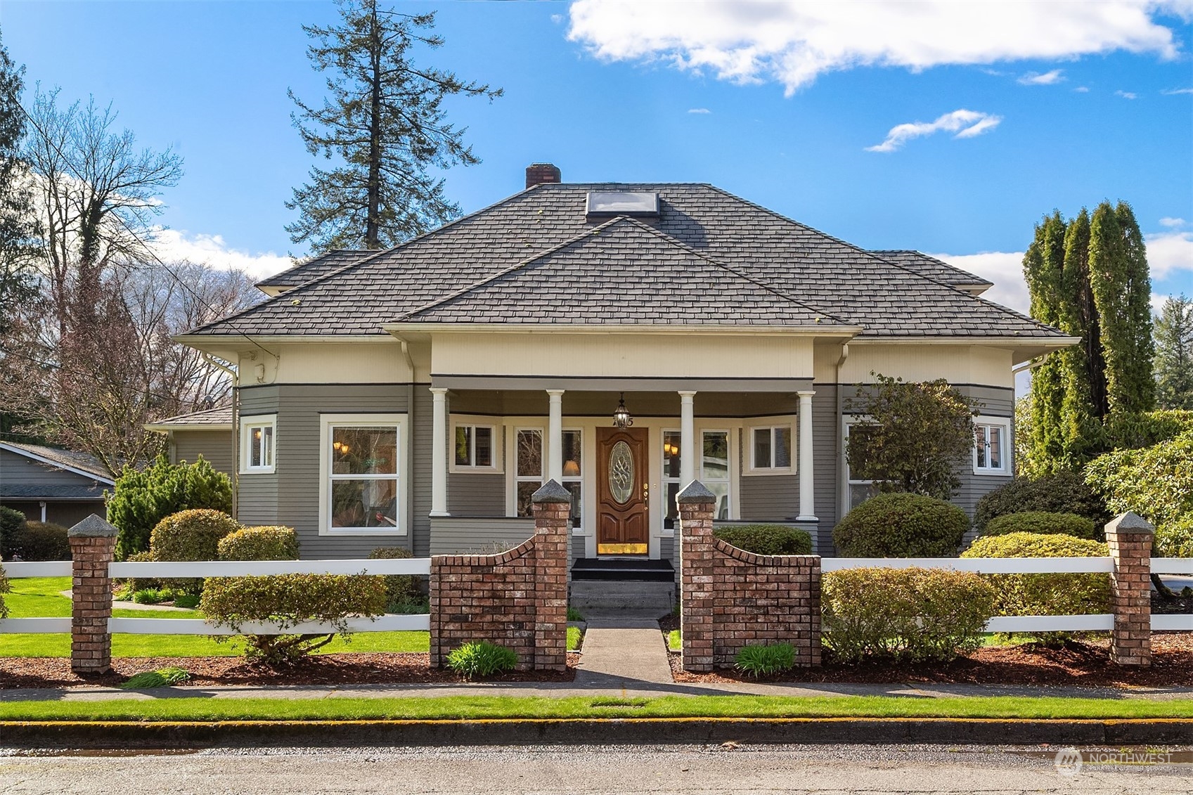 a front view of a house with a yard table and chairs