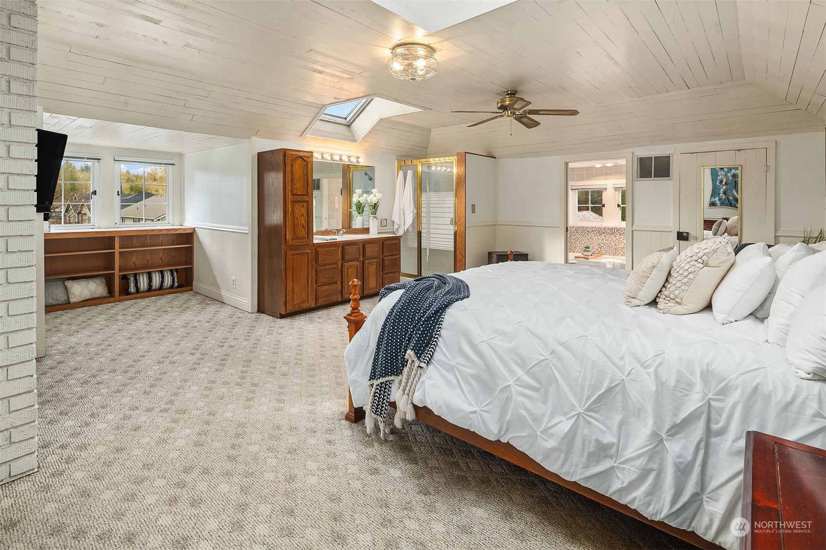 705 3rd Street Sultan, WA 98294 - Photo 9 of 26 a bedroom with a bed a mirror and a flat tv screen