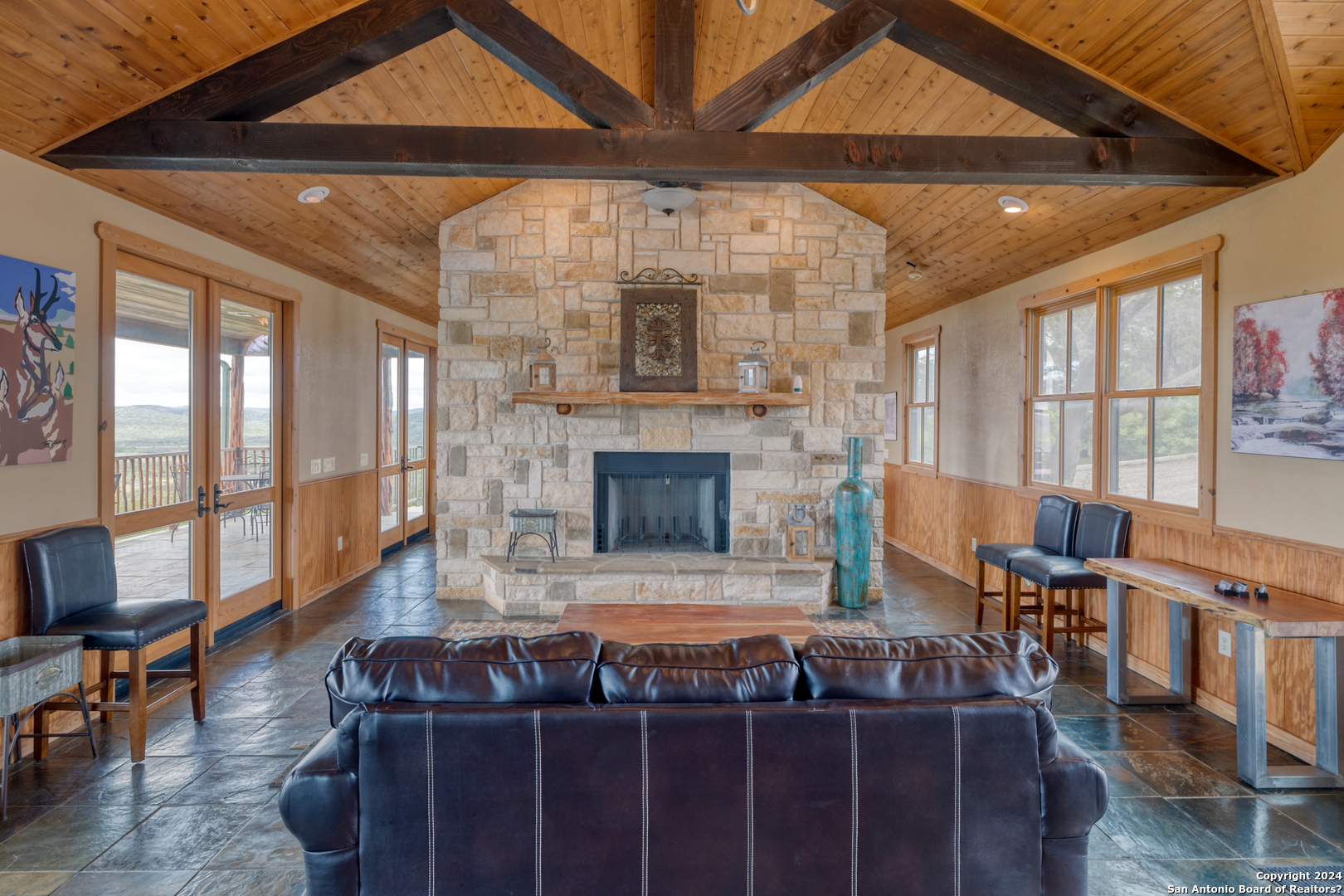 558 South Ridge Drive Concan, TX 78838 - Photo 15 of 35 a living room with furniture a flat screen tv and a fireplace