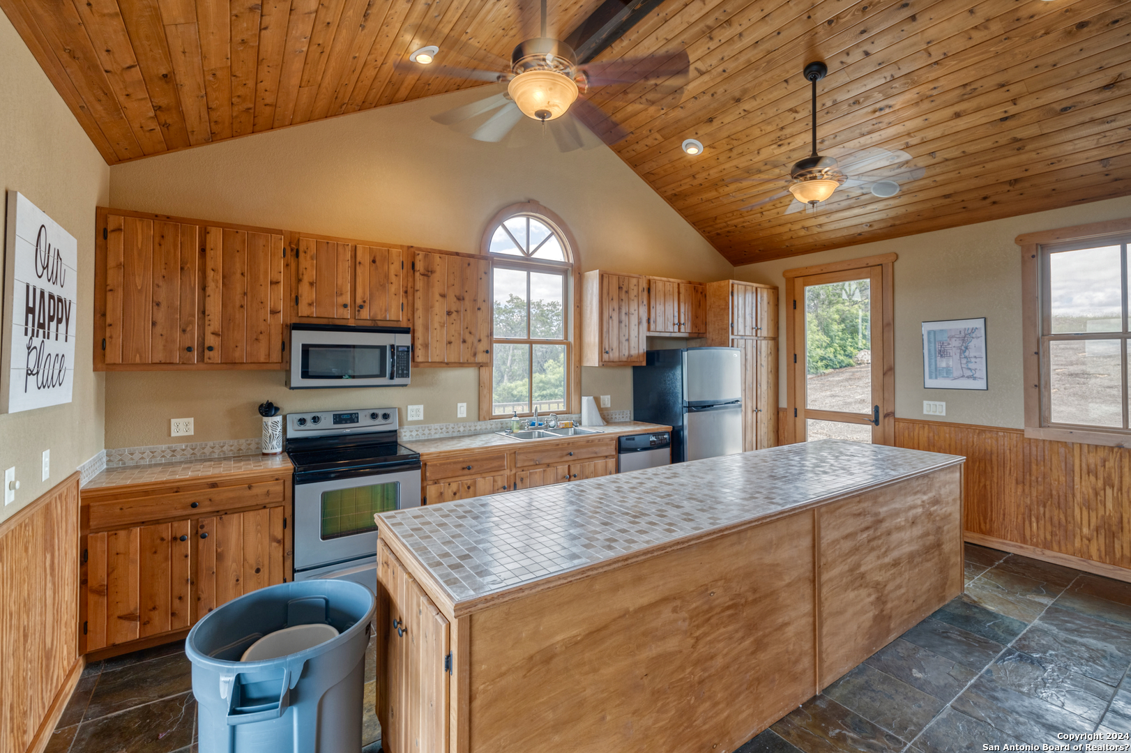 558 South Ridge Drive Concan, TX 78838 - Photo 16 of 35 a kitchen with microwave a stove and chairs