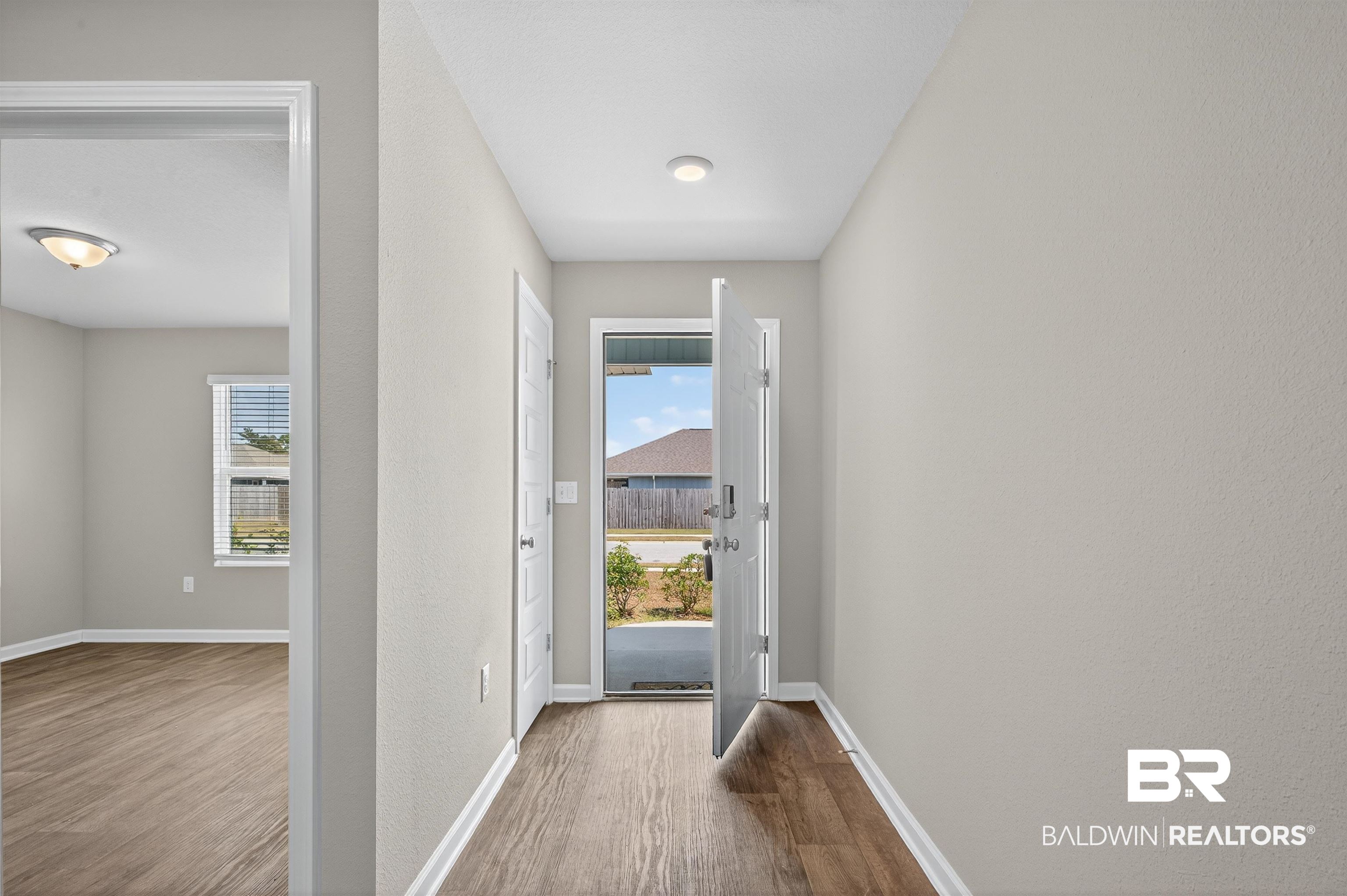 7429 Brompton Drive Foley, AL 36535 - Photo 32 of 50 Doorway to outside featuring wood finished floors and baseboards