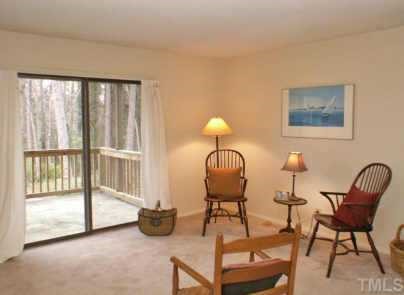 5010 Flint Ridge Place Raleigh, NC 27609 - Photo 6 of 12 Living room and sliding glass door to deck