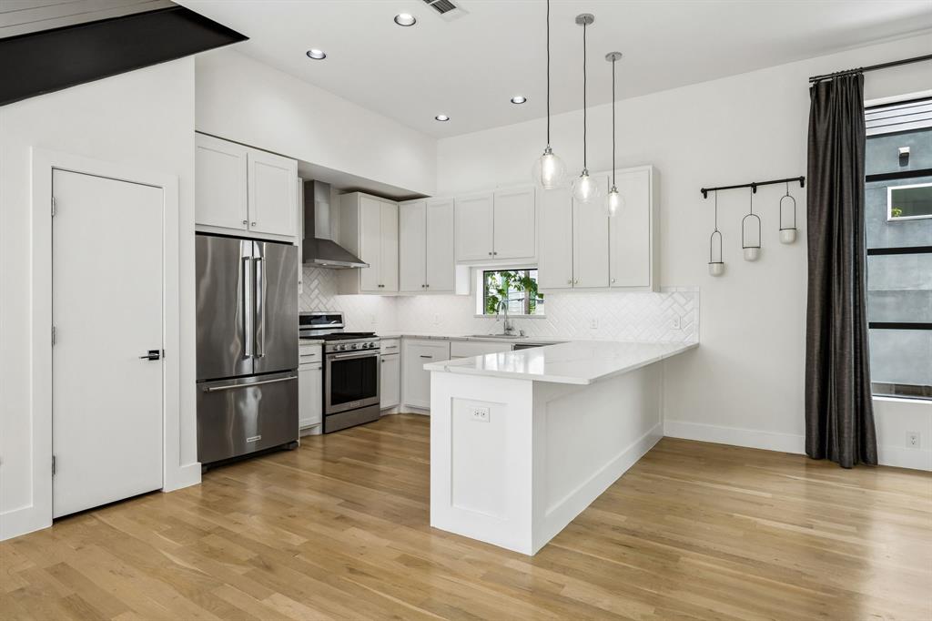 1851 Summit Avenue, Unit 4 Dallas, TX 75206 - Photo 7 of 29 a kitchen with stainless steel appliances a refrigerator sink and microwave