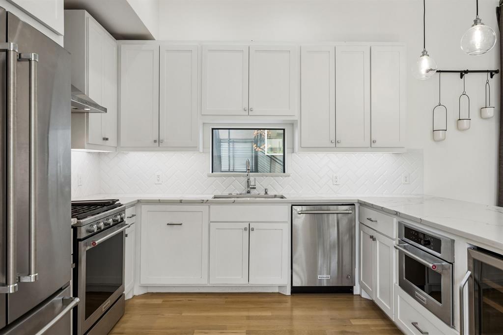 1851 Summit Avenue, Unit 4 Dallas, TX 75206 - Photo 10 of 29 a kitchen with stainless steel appliances granite countertop a stove a sink and a microwave