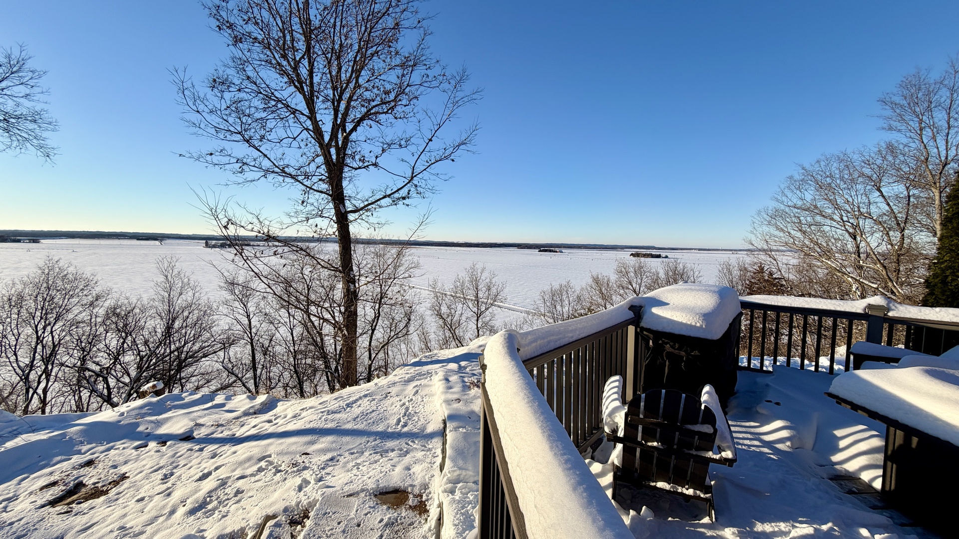 9120 Spring Valley Road Fulton, IL 61252 - Photo 13 of 59 a view of a balcony with chairs and wooden fence