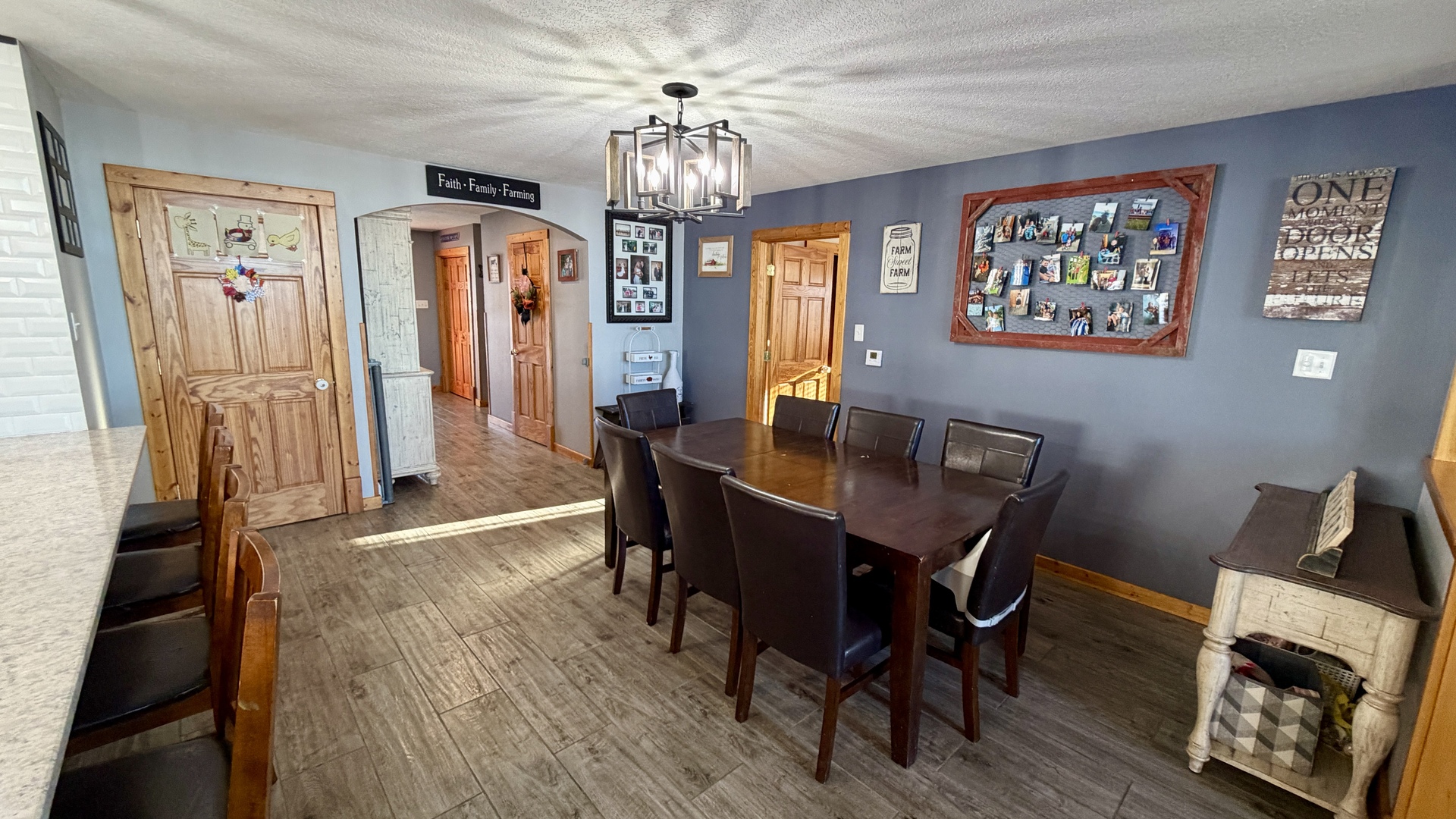 9120 Spring Valley Road Fulton, IL 61252 - Photo 24 of 59 a view of a dining room with furniture a chandelier and wooden floor